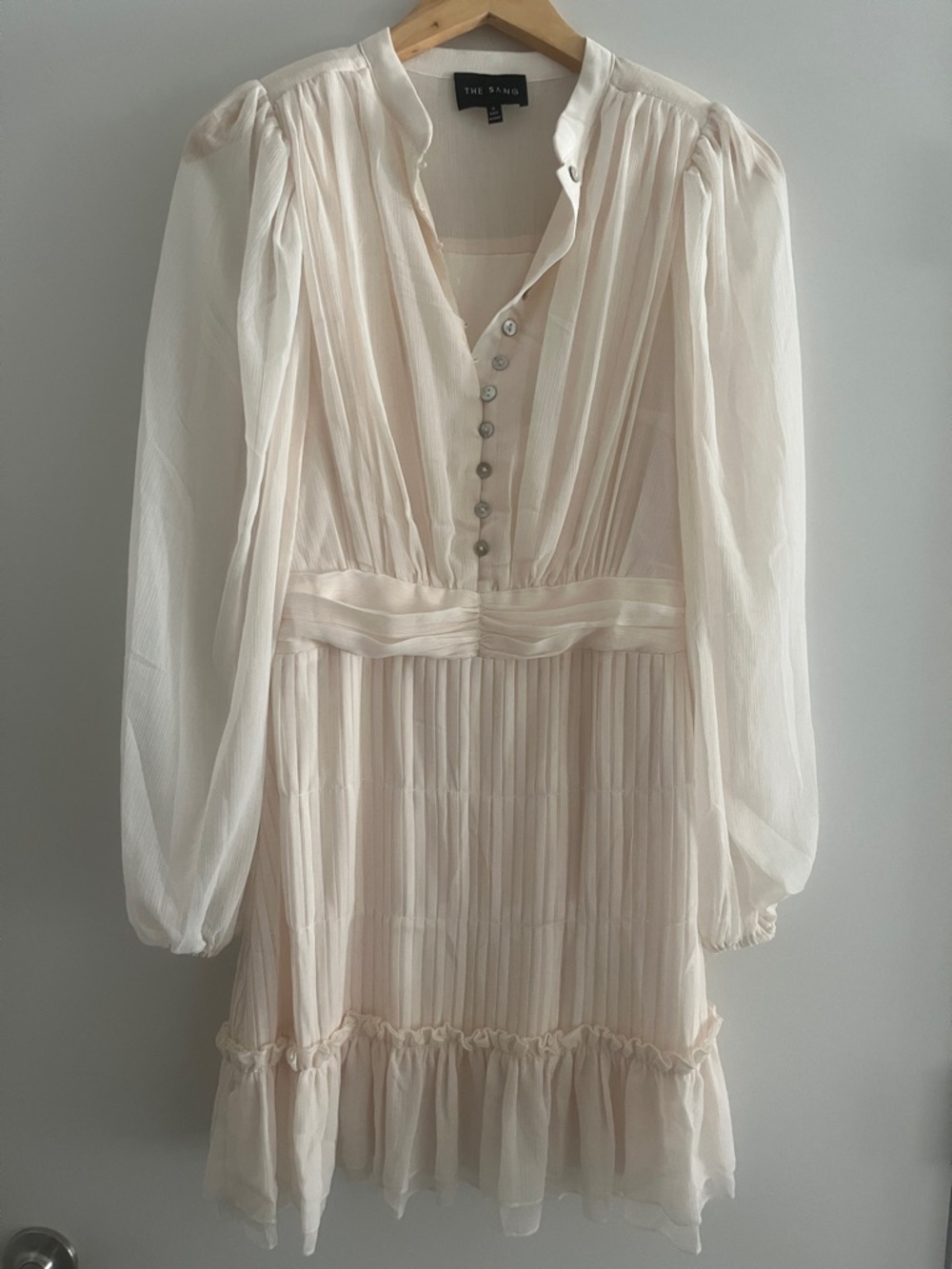 The SANG Long Sleeve Pleated Mini Dress in Light Cream